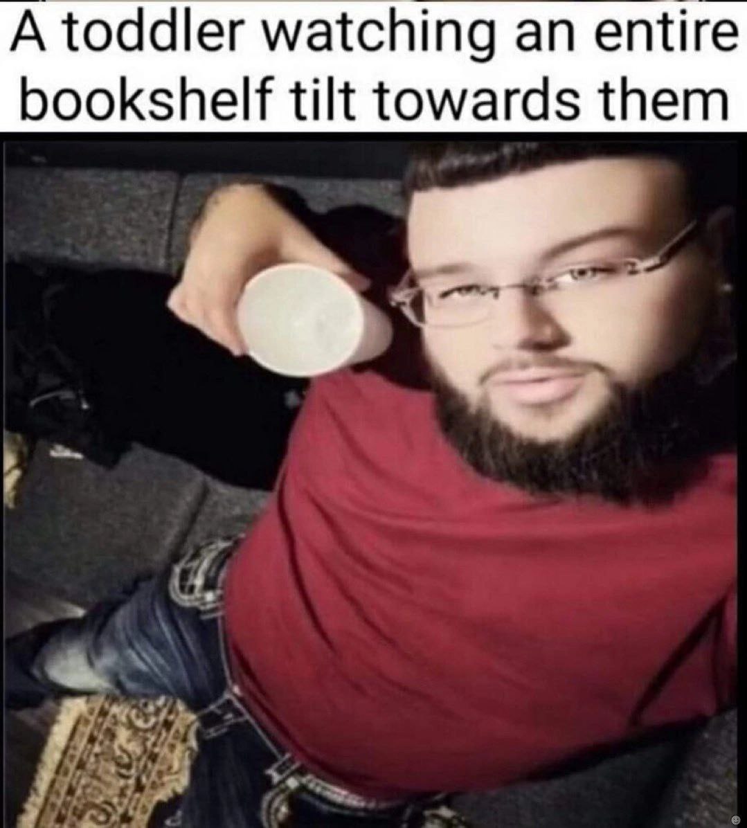 A toddler watching an entire bookshelf tilt towards them
