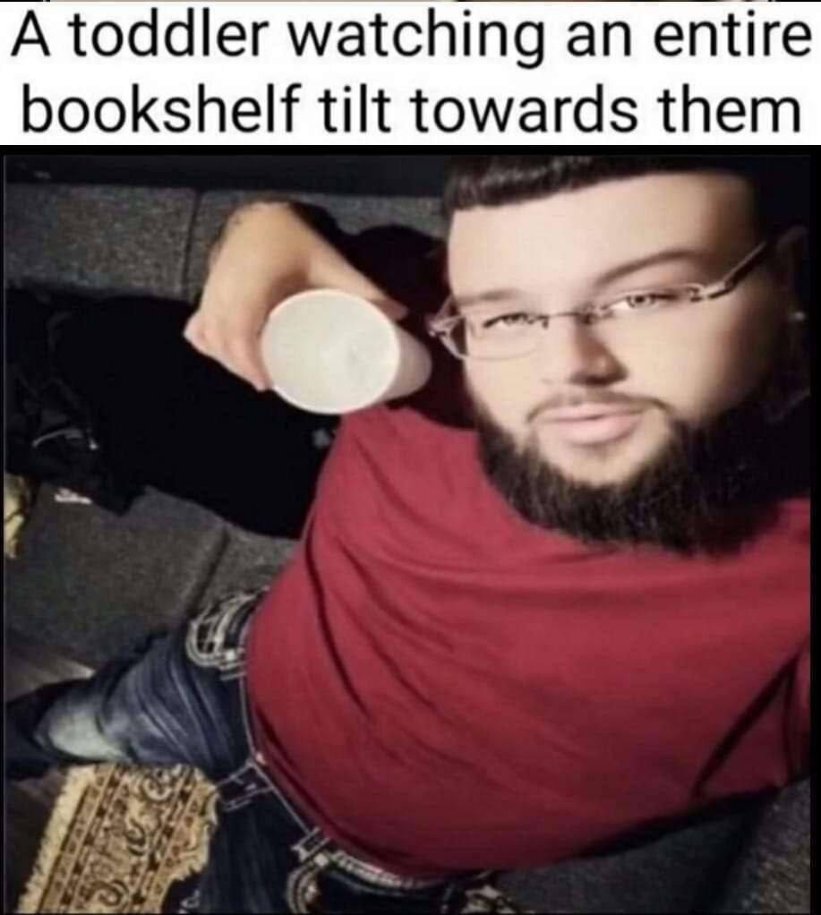 A toddler watching an entire bookshelf tilt towards them