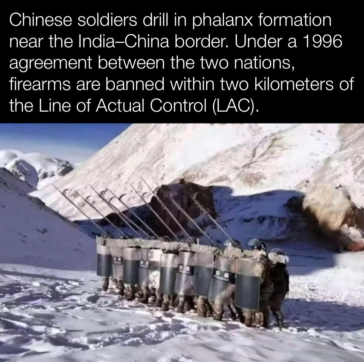 Chinese soldiers drill in phalanx formation near the India—China border. Under а 1996 agreement between the two nations, firearms are banned within two kilometers of the Line of Actual Control (LAC).