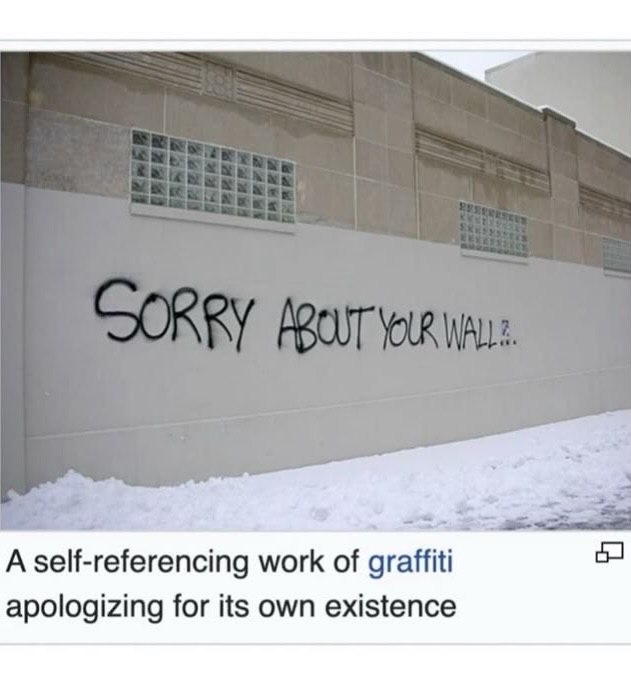 A self-referencing work of graffiti apologizing for its own existence