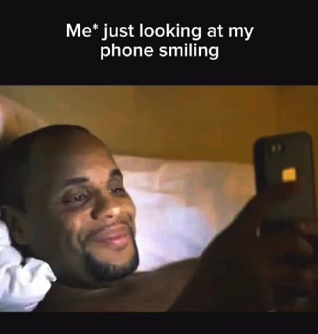 just looking at phone smiling