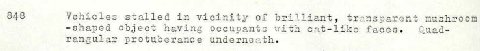 848 Vehicles stalled in vicinity of brilliant, trensparent -shaped object having occuvants with cat-like faces. Cuad- rangular protuberance